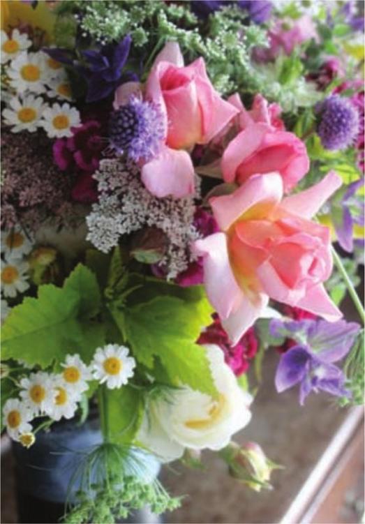 A mixed bouquet of flowers fresh from the garden including roses feverfew - photo 3