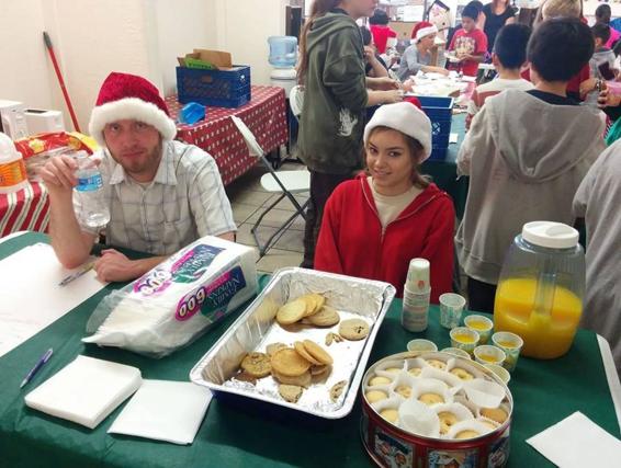 Ariana and Rick help out at a large Christmas party for Sixth Street Elementary - photo 2