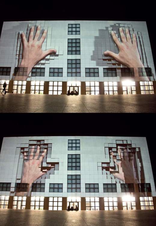 00 Urban Screen Gigantic fingers appear to distort the walls of the - photo 3