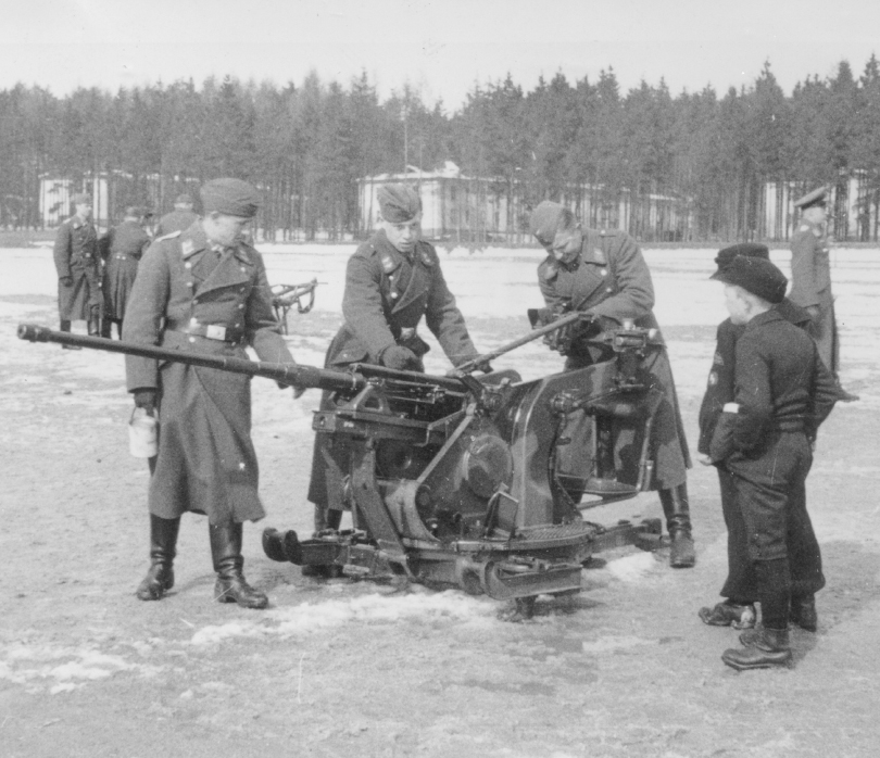 Two young Hitlerjugend cadets observe with interest a Luftwaffe FlaK crew - photo 2