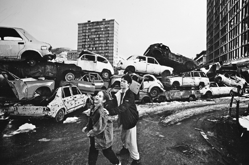 Children play behind a barricade of cars shredded by artillery and bullets The - photo 7