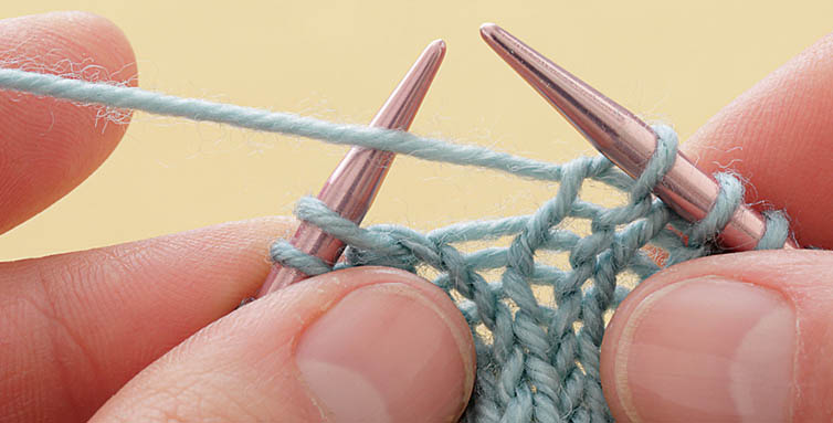 Move the yarn up and over the right needle to the back in position to knit the - photo 6