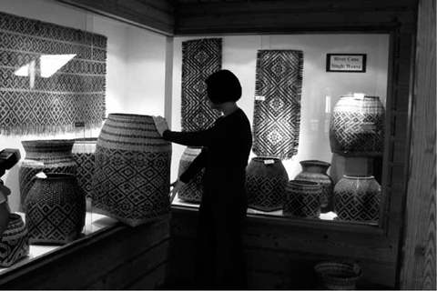 Project Assistant Tonya Carroll with baskets in the permanent collection of - photo 4